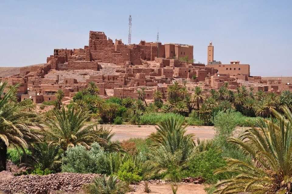 The Kasbah of Tifoultoute on its hill above palm trees and the river valley, west of Ouarzazate